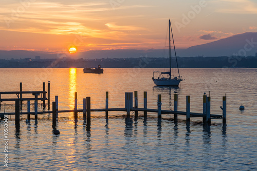 Beautiful sunset in the lake with a sailboat © Fominayaphoto
