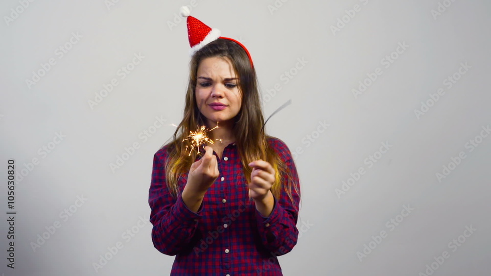 young girl with christmas hat and two sparklers sad emotion young girl with christmas hat and two sparklers sad emotion