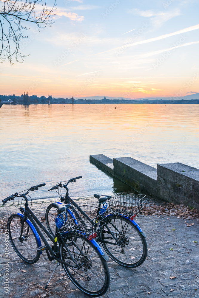  A pair of bicycles in the lake at sunset