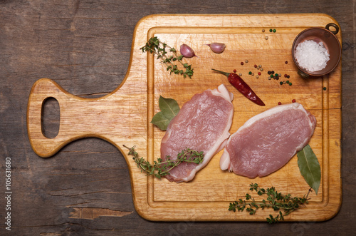 Fresh meat steaks on light wooden cutting board