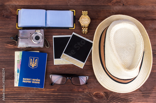 Travel set, summer vacation, tourism objects and concepts. White hat, camera, sunglasses, passport, watch, notebook, money, a geographical map. Photos in retro style