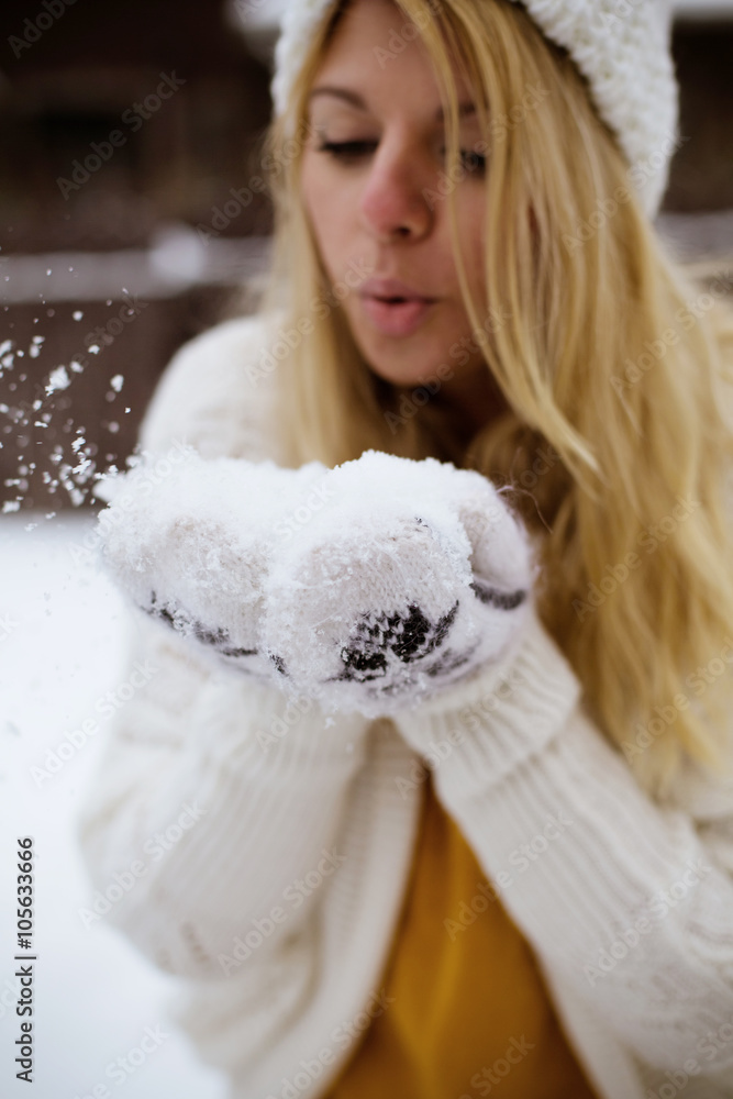 woman throwing snow in the air on winter holidays woman throwing snow in the air on winter holidays