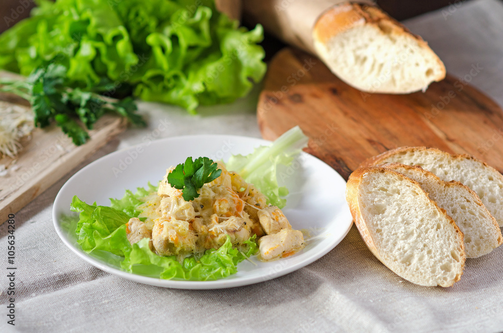 Chicken fillet with cheese, served with fresh greens and French baguette Chicken fillet with cheese, served with fresh greens and French baguette
