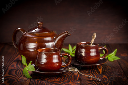 Cup with green tea on wooden background