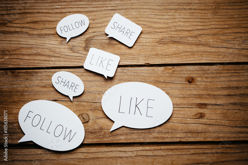 Social media on wooden background.