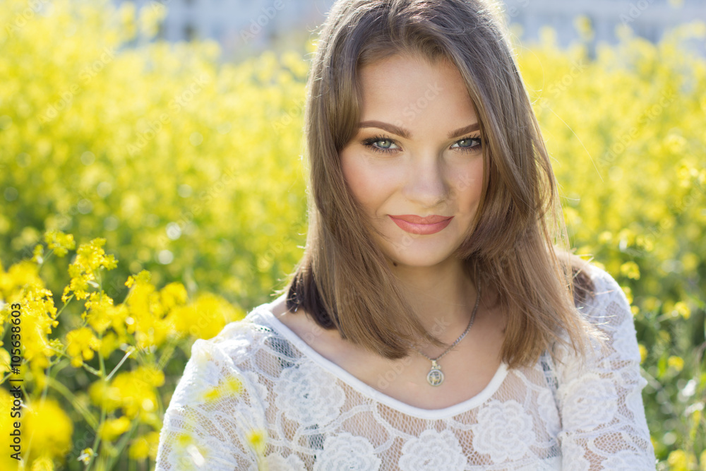 Pretty girl in field with yellow flowers Pretty girl in field with yellow flowers