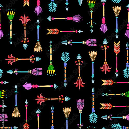 Vector seamless pattern with hand drawn tribal arrows on black c