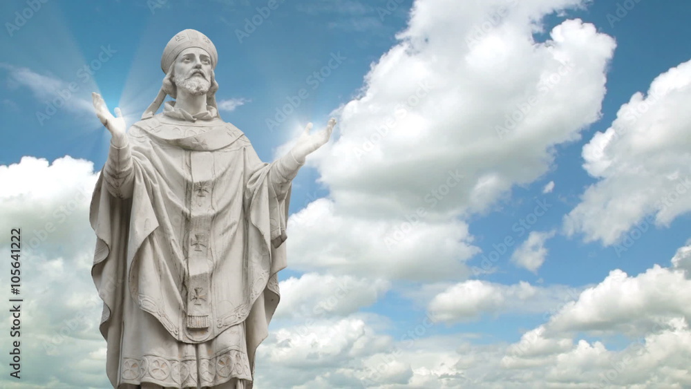 Timelapse of the statue of a priest with light streaks coming from hands