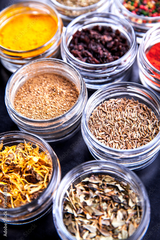 Spices on black background in special jars. Food Spices on black background in special jars. Food