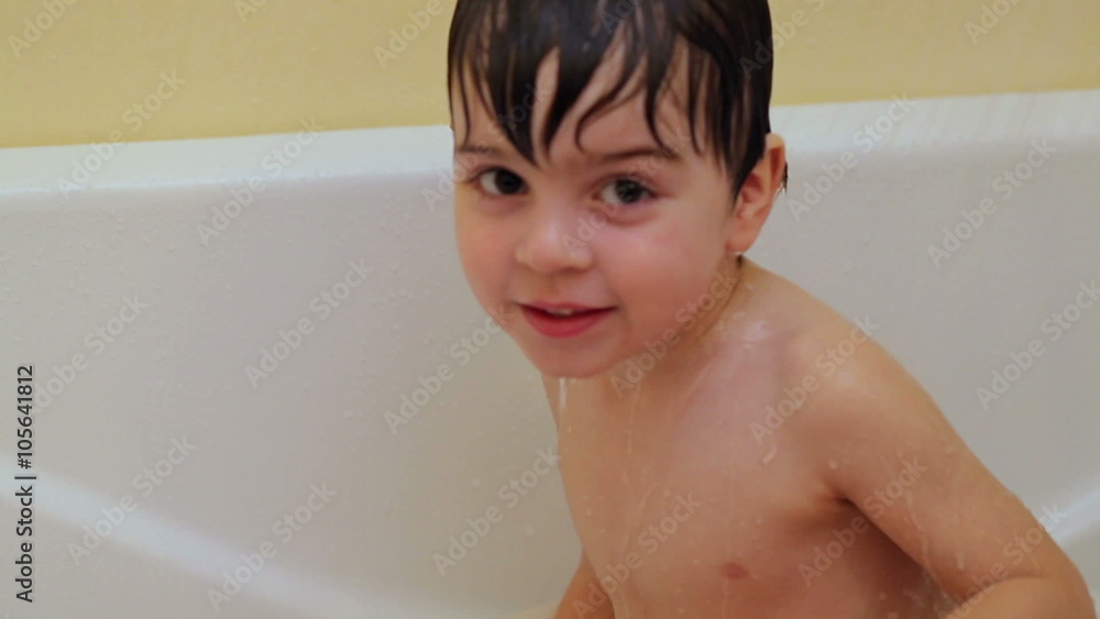 Emotional little boy taking a bath alone. 