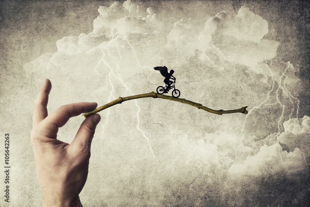 Boy riding a bicycle try to jump over a chasm. Self overcoming and risk taking concept - obrazy, fototapety, plakaty 