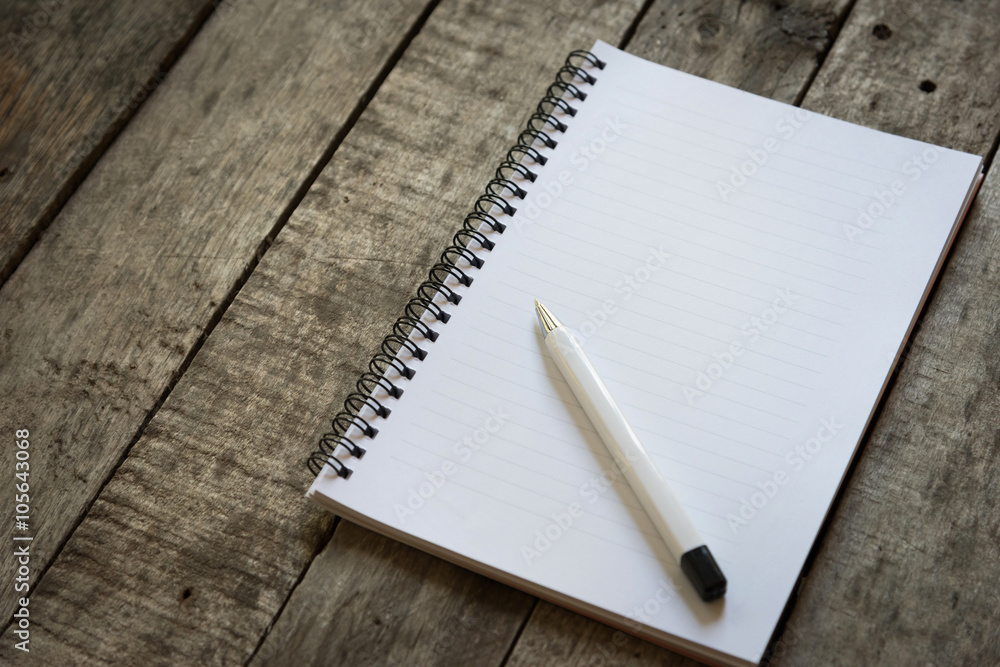 pen and notepad on wooden floor pen and notepad on wooden floor