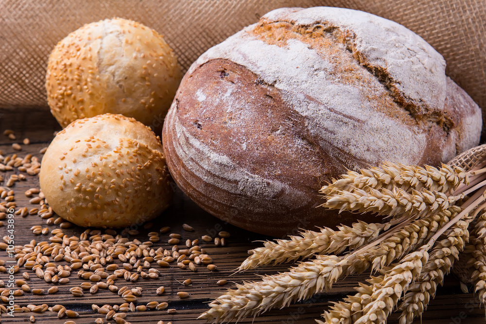 Assortment of baked bread on wooden table background Assortment of baked bread on wooden table background