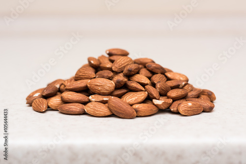 Dried almonds on the kitchen table © zlatamarka