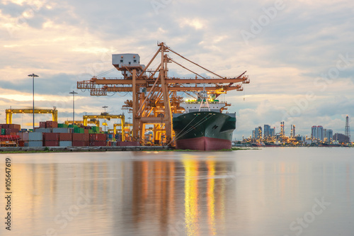 Industrial Container Cargo freight ship with working crane in sh