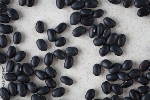 Black turtle beans on bright surface top view
