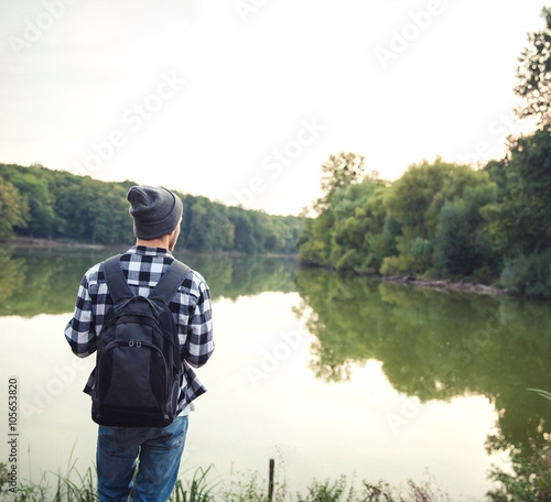 Young Man standing alone outdoor Travel Lifestyle concept with lake © serbogachuk