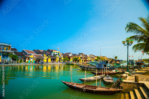 Traditional boats in front of ancient architecture in Hoi An, Vietnam. Hoi An is the World's Cultural heritage site, famous for mixed cultures & architecture. © romas_ph
