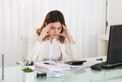 Depressed Businesswoman Calculating Invoice © Andrey Popov