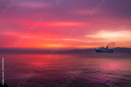 sunset with cruise ship at twilight on Aegean sea, Greece