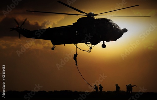 Photography Helicopter dropping soldier during sunset