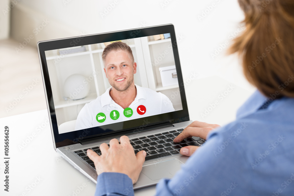 Woman Video Chatting On Laptop