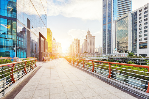 empty footpath between modern buildings at sunrise in guangzhou