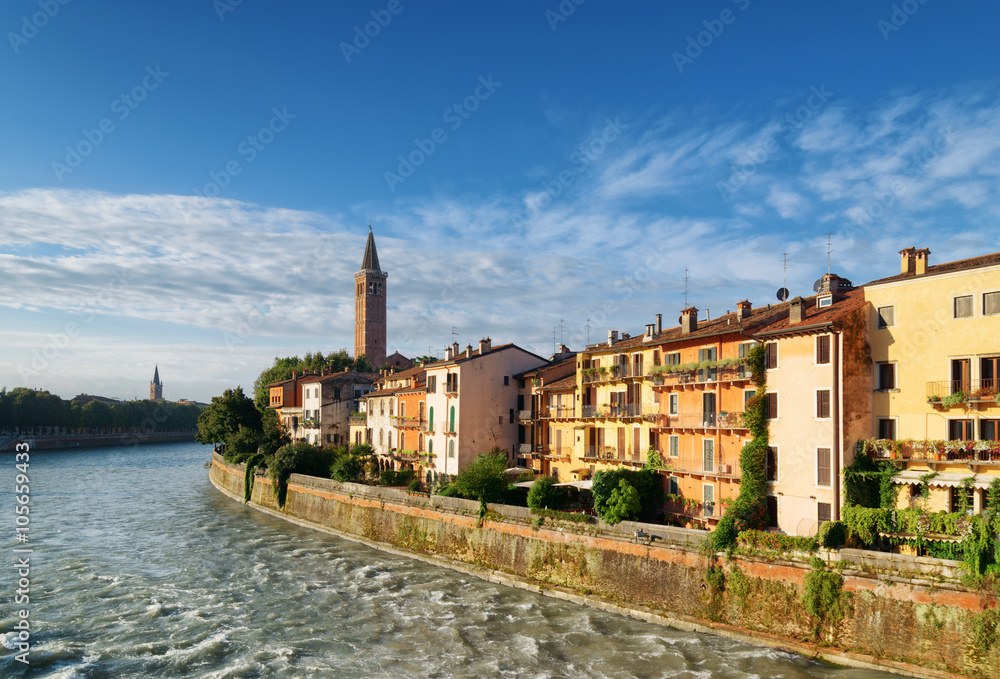 Facades of old houses on waterfront of Adige River in Verona