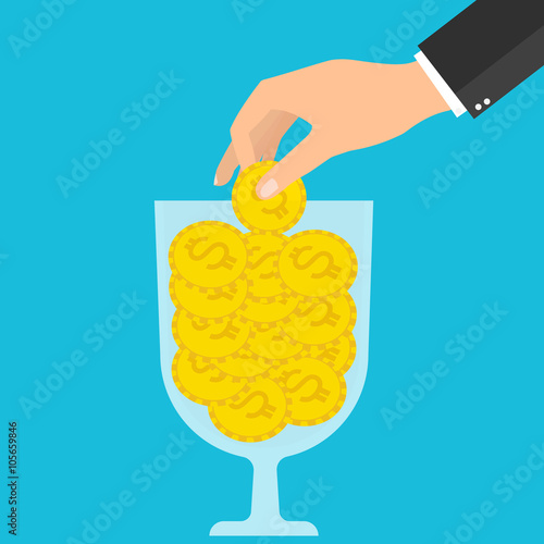 Businessman hand putting gold coins into a wine glass. 