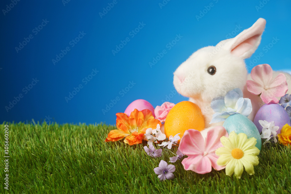 Fototapeta premium Festive Easter background with rabbit, flowers, and colorful egg