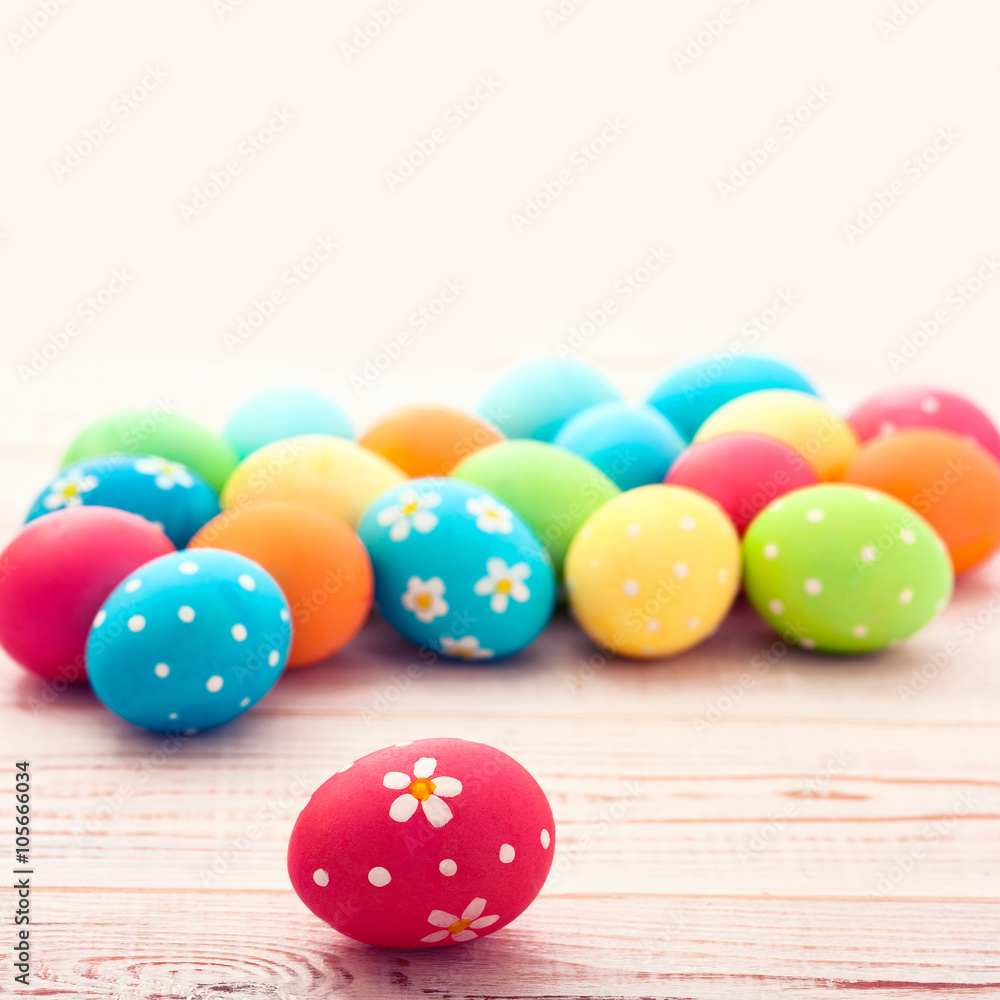 Colorful easter eggs and branch with flowers. Top view, square. Poster, mock up for design. Selective focus Colorful easter eggs and branch with flowers. Top view, square. Poster, mock up for design. Selective focus