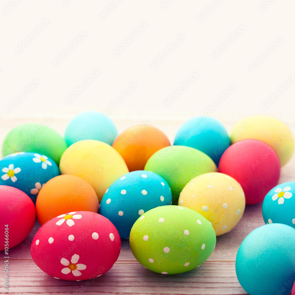 Colorful easter eggs and branch with flowers. Top view, square. Poster, mock up for design. Selective focus Colorful easter eggs and branch with flowers. Top view, square. Poster, mock up for design. Selective focus