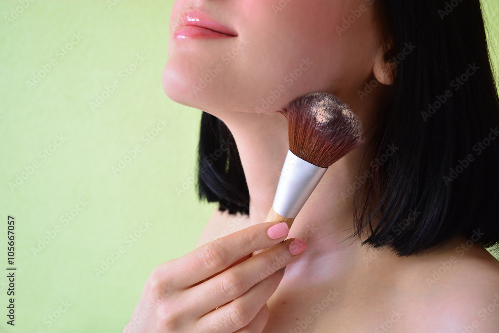 Young woman putting powder on with brush. Applying powder. Makeup Young woman putting powder on with brush. Applying powder. Makeup
