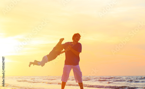 father and son having fun at sunset