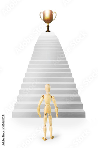 Man stands in front of stairs ascending up to the prize. Abstract image with a wooden puppet
