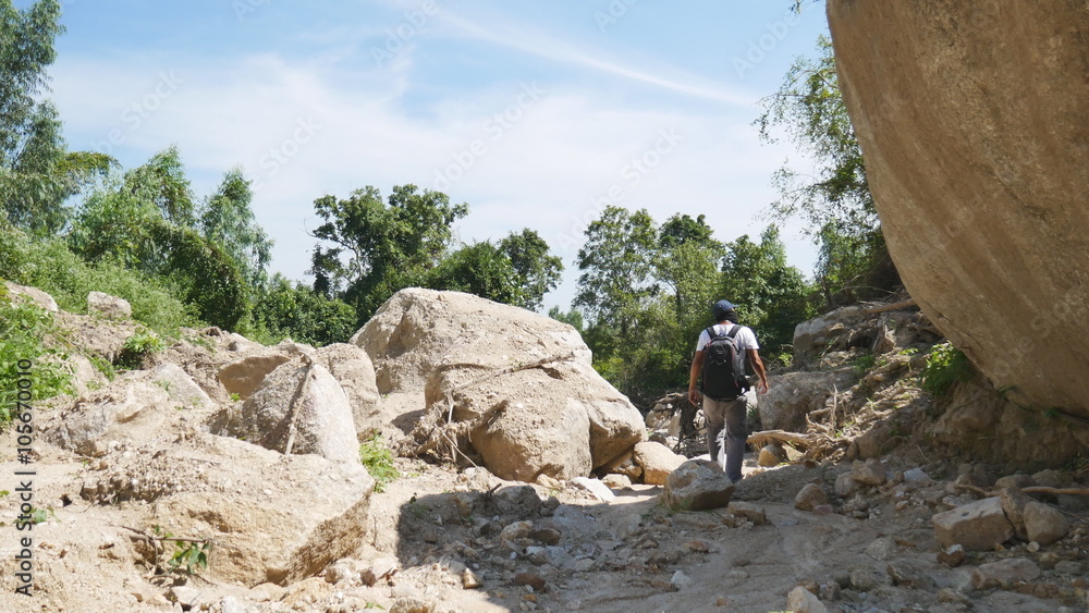 A tourist man hikes away alone in forest A tourist man hikes away alone in forest