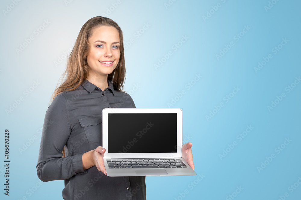 Portrait of a happy cute woman showing blank laptop screen Portrait of a happy cute woman showing blank laptop screen