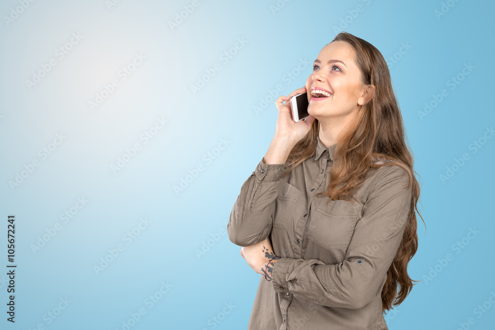 Laughing woman talking on the phone and looking up Laughing woman talking on the phone and looking up