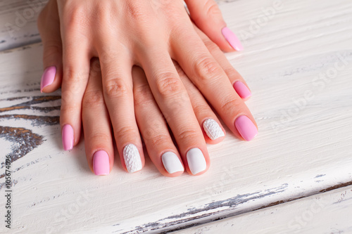 White-pink manicure with ornaments.