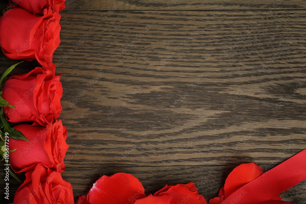 red roses in a row on wood table, directly above