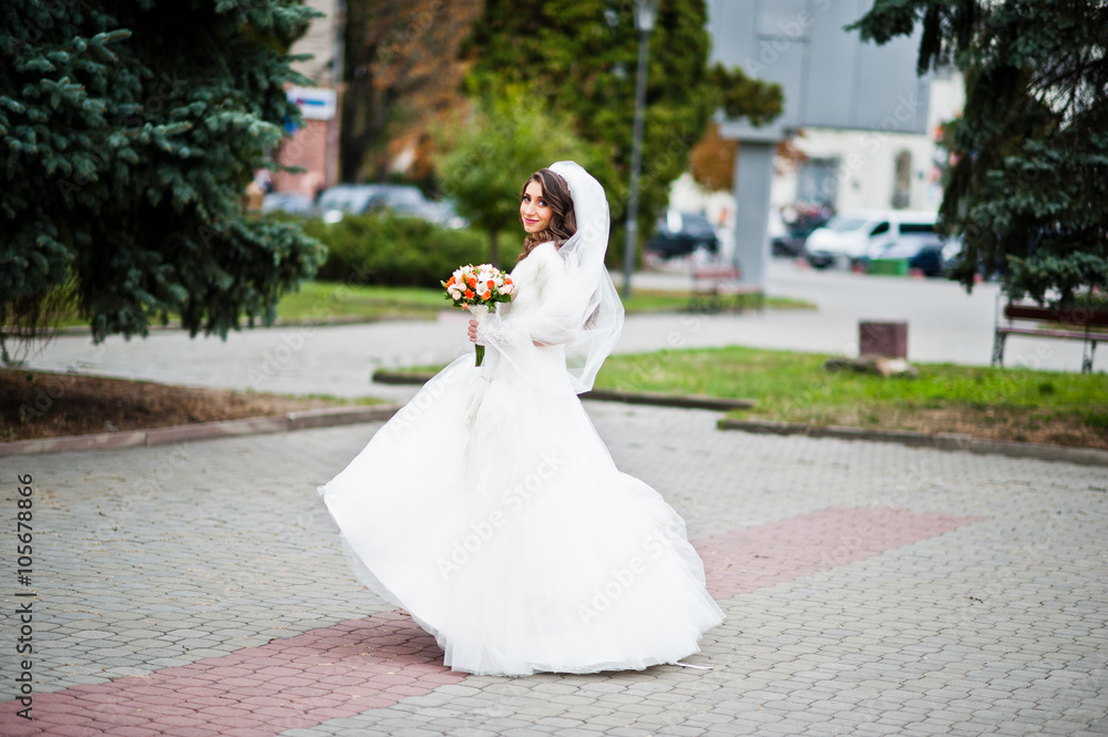 Portrait of charming curly bride in a fur coat Portrait of charming curly bride in a fur coat