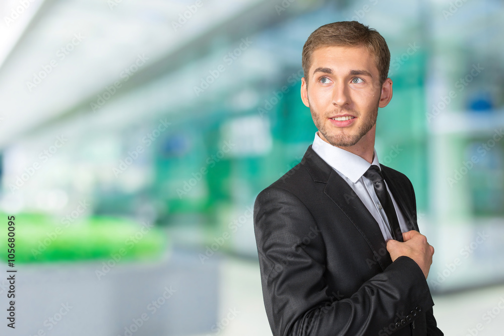 Young handsome businessman adjusting his tie Young handsome businessman adjusting his tie