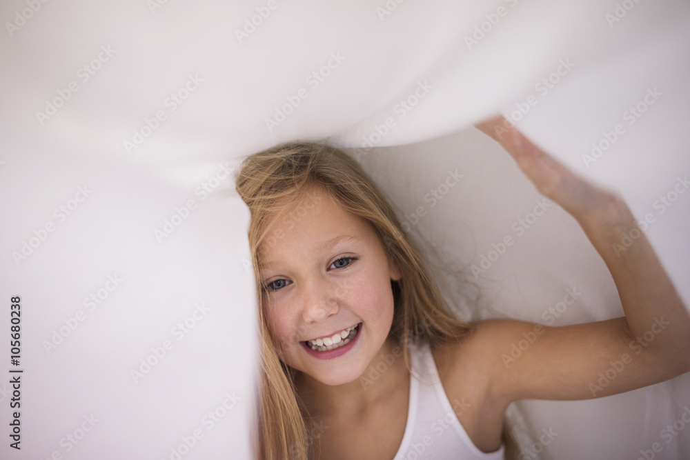 Little girl hiding under the sheet. Little girl hiding under the sheet.