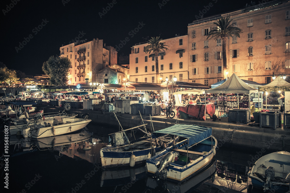 Small wooden boats moored in Ajaccio at night
