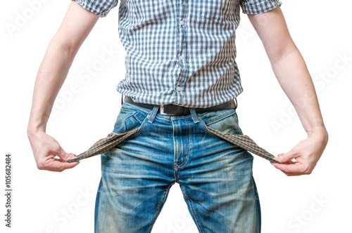 Man - debtor is showing empty pockets of his jeans as symbol of no money Fototapet