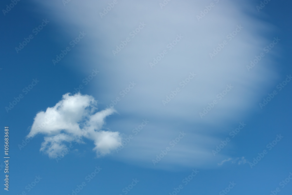 Two different clouds against blue sky. Two different clouds against blue sky.