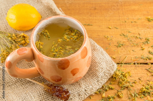 St Johns wort tea and surrounded by dried plants photo