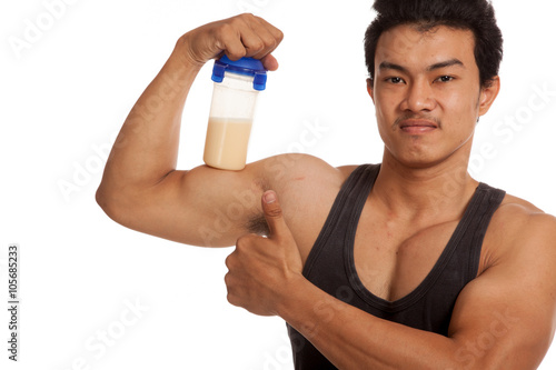 Muscular Asian man flexing biceps and thumbs up with whey prote