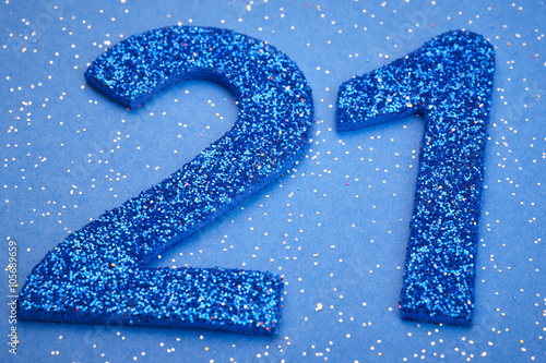 Number twentyone blue color over a blue background. Anniversary. photo