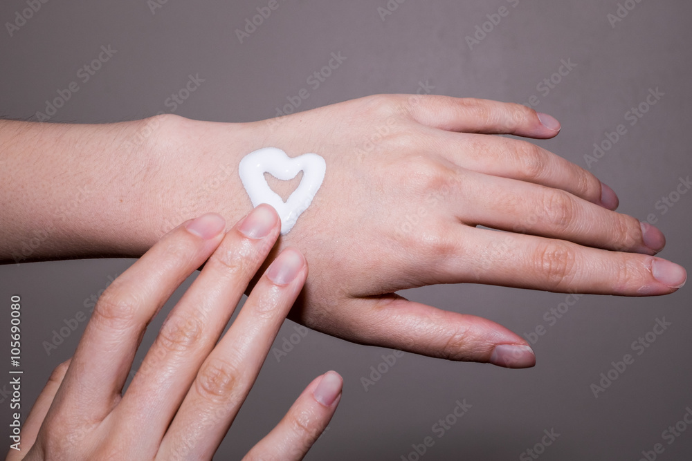 Woman applying moisturizing cream on hands Woman applying moisturizing cream on hands